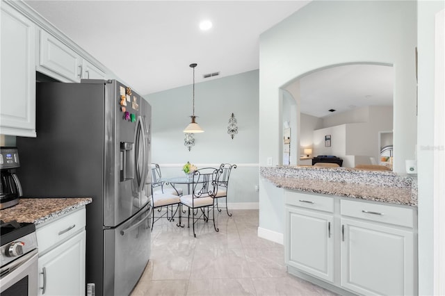 kitchen featuring visible vents, arched walkways, stainless steel electric range oven, light stone countertops, and white cabinetry