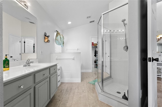 full bath with lofted ceiling, visible vents, baseboards, vanity, and a shower stall