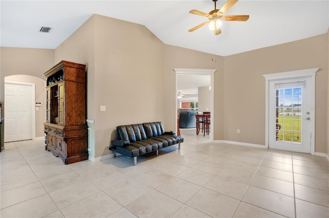 sitting room featuring light tile patterned floors, baseboards, visible vents, a ceiling fan, and vaulted ceiling