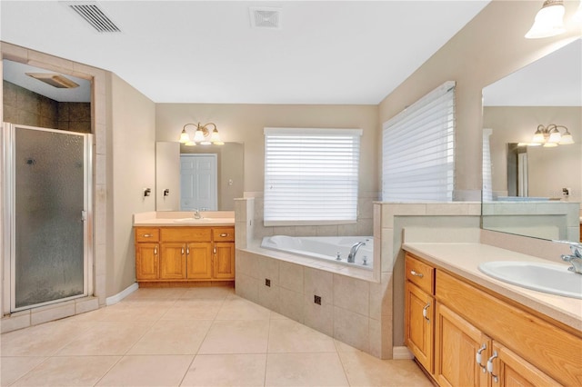 bathroom with a stall shower, visible vents, a sink, and tile patterned floors