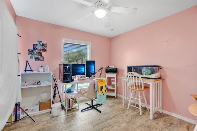 home office featuring ceiling fan, baseboards, and wood finished floors