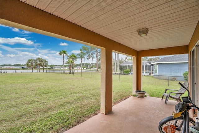 view of patio / terrace featuring a water view and fence