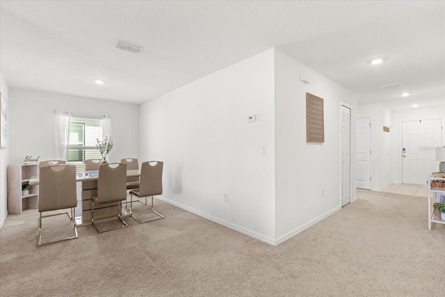 carpeted dining room with recessed lighting and baseboards