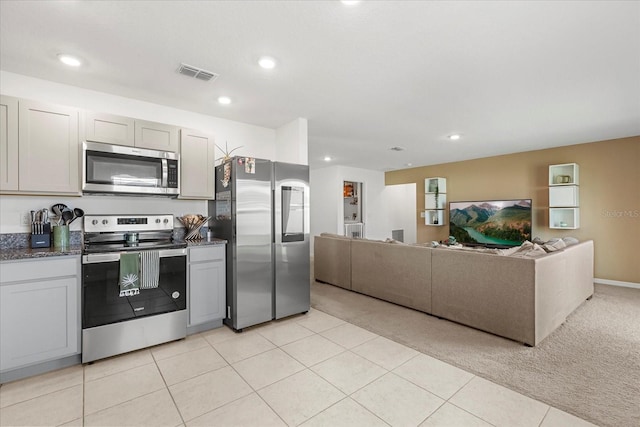 kitchen featuring stainless steel appliances, light colored carpet, visible vents, and recessed lighting