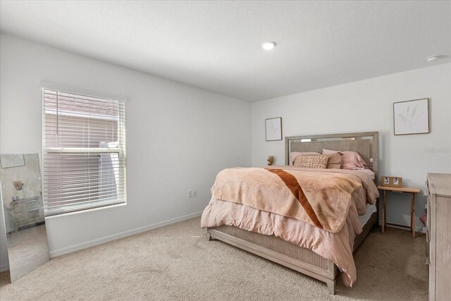 bedroom with baseboards and carpet flooring