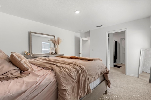 bedroom with light carpet, baseboards, and visible vents