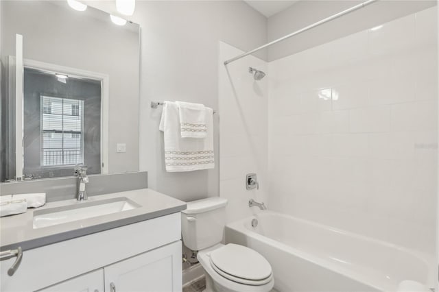 bathroom featuring toilet, vanity, and shower / tub combination