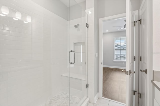 full bathroom featuring baseboards and a stall shower