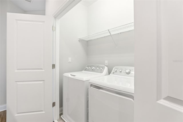 laundry room with washing machine and clothes dryer and laundry area