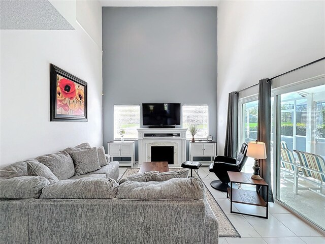 living room with a high ceiling and a fireplace