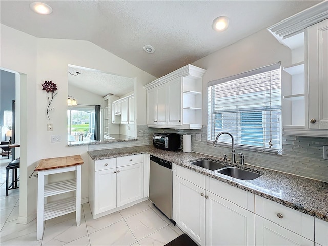 kitchen with open shelves, stainless steel dishwasher, white cabinets, vaulted ceiling, and a sink