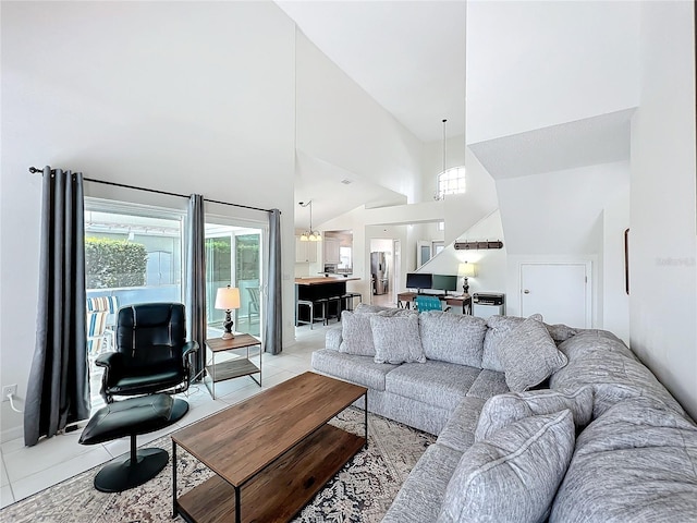 living area with light tile patterned floors and high vaulted ceiling