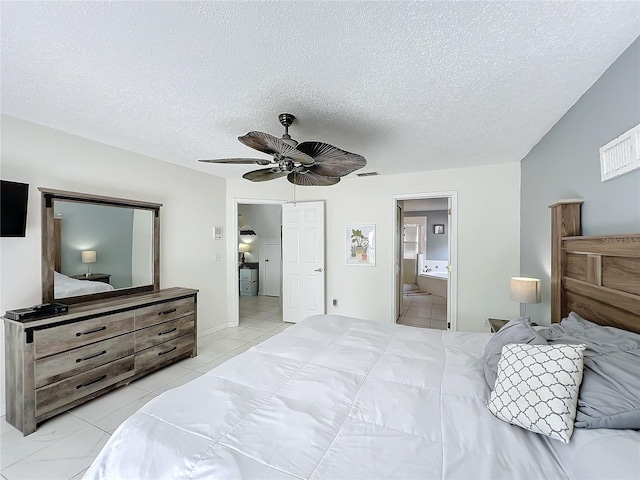 bedroom featuring a textured ceiling, ensuite bathroom, visible vents, and a ceiling fan