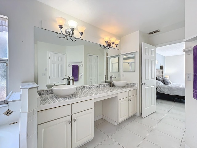 full bathroom with double vanity, visible vents, ensuite bath, an inviting chandelier, and a sink