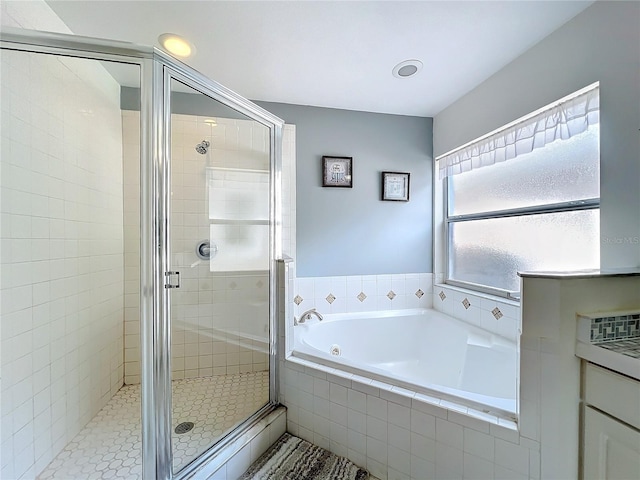 bathroom with a garden tub and a shower stall