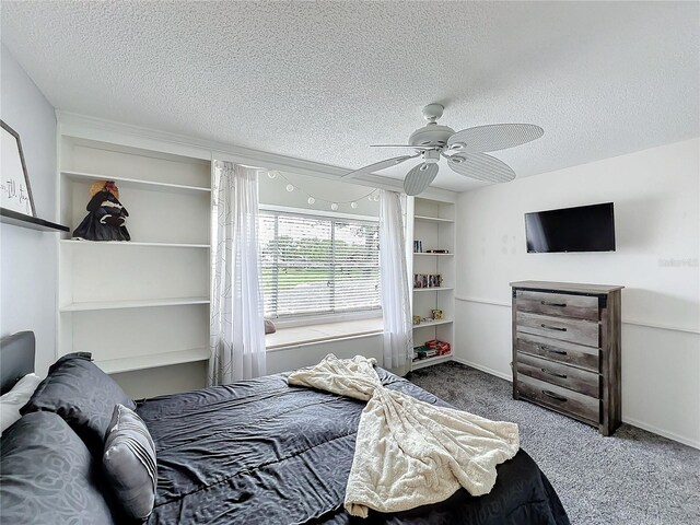 carpeted bedroom with a textured ceiling, a ceiling fan, and baseboards