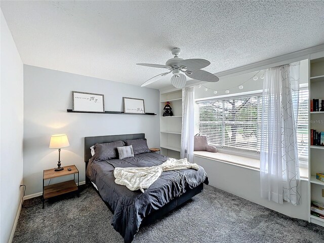 carpeted bedroom with a ceiling fan, a textured ceiling, and baseboards