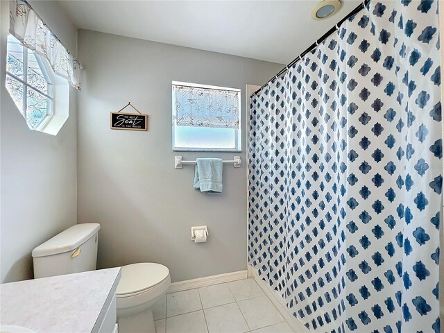 full bathroom with toilet, tile patterned flooring, baseboards, and vanity