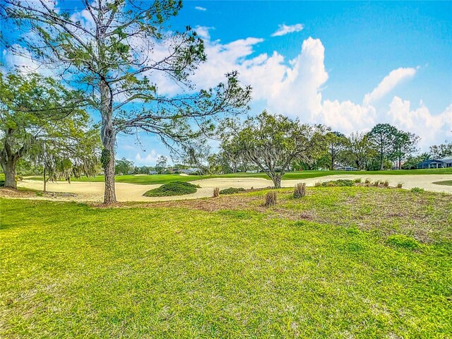 surrounding community featuring a lawn and driveway