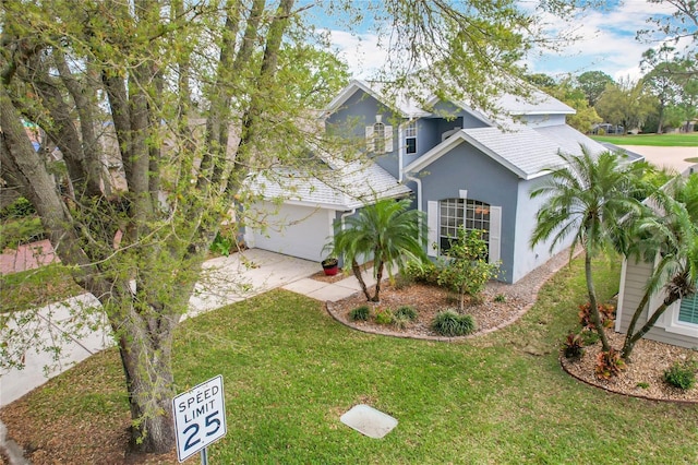 view of front of property with driveway, a front lawn, and stucco siding