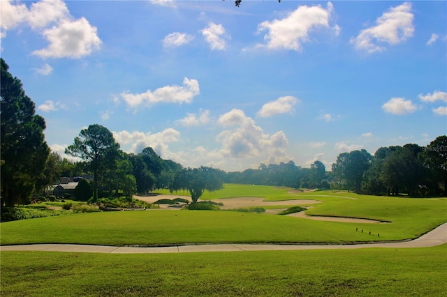 view of community with a yard and golf course view