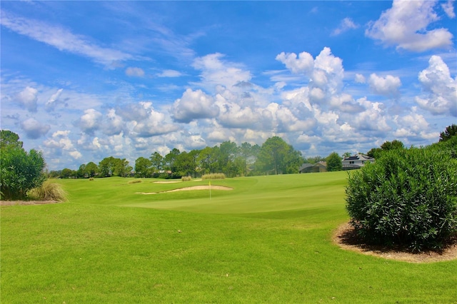 surrounding community with a lawn and golf course view