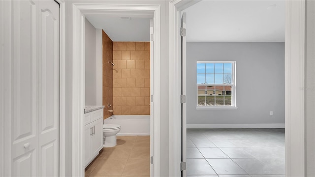 bathroom with shower / washtub combination, toilet, vanity, baseboards, and tile patterned floors