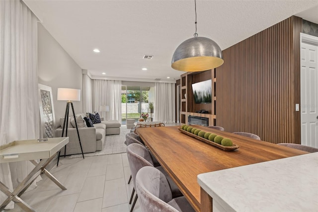 dining area with light tile patterned flooring, recessed lighting, visible vents, and a textured ceiling