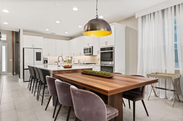 dining room with light tile patterned floors and recessed lighting