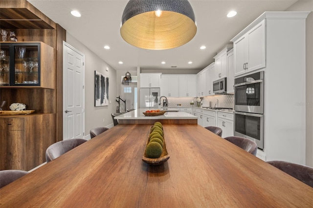 dining area with stairway and recessed lighting