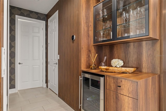 bar featuring beverage cooler and a dry bar