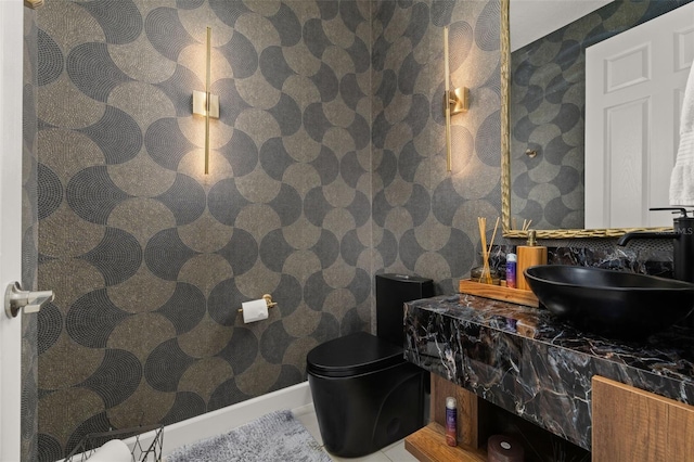 bathroom with baseboards and vanity