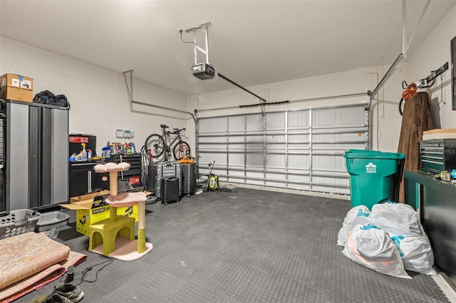 garage with concrete block wall and a garage door opener