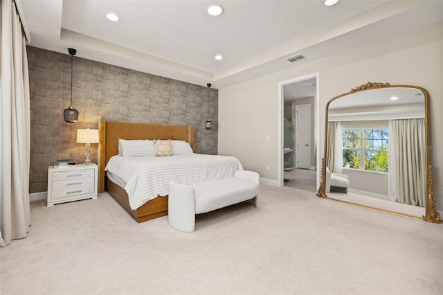 carpeted bedroom featuring an accent wall, recessed lighting, visible vents, and baseboards