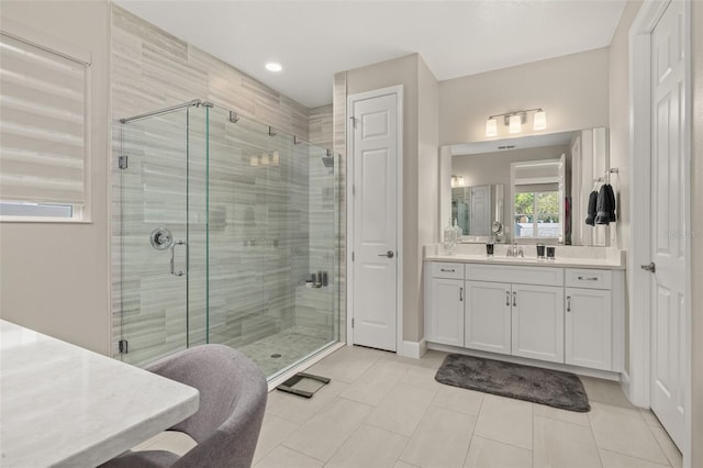 bathroom with vanity, a shower stall, and tile patterned floors