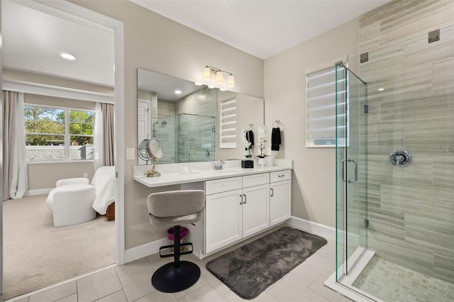 full bathroom with tile patterned floors, a shower stall, vanity, and baseboards