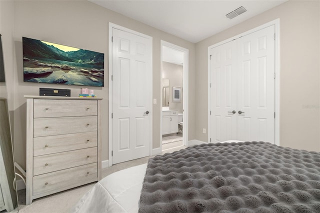 carpeted bedroom with baseboards, visible vents, a closet, and connected bathroom