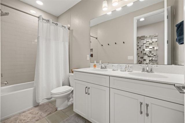 bathroom with a sink, toilet, shower / bath combo, and double vanity