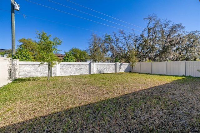 view of yard with a fenced backyard