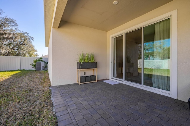 view of patio with central AC and fence