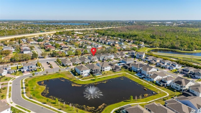 drone / aerial view featuring a residential view and a water view