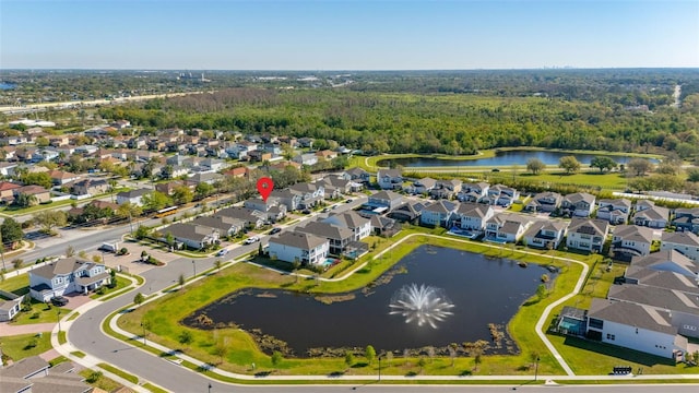 aerial view featuring a residential view, a view of trees, and a water view