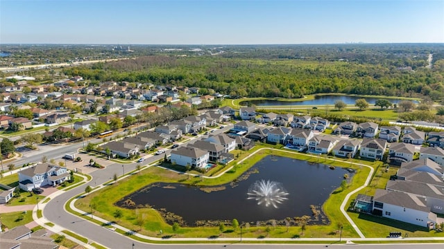 birds eye view of property with a residential view, a view of trees, and a water view