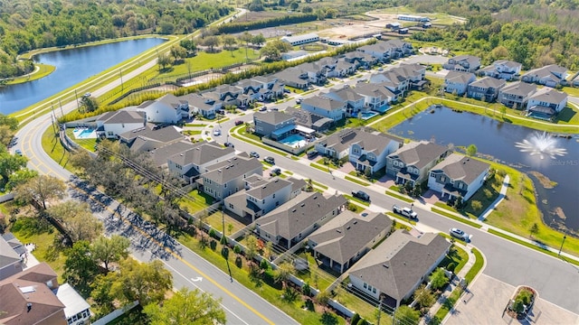 drone / aerial view featuring a residential view and a water view