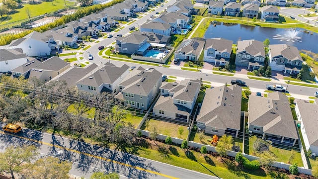 drone / aerial view featuring a residential view and a water view