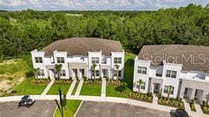 aerial view featuring a residential view and a view of trees