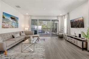 living area with recessed lighting and wood finished floors