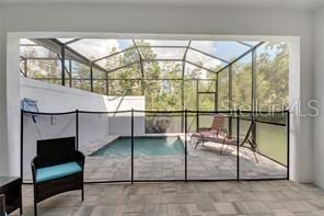 view of pool with a patio and a lanai