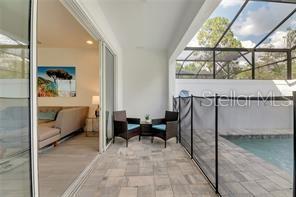 view of patio / terrace featuring glass enclosure