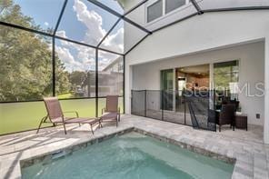 view of swimming pool with a patio and a lanai